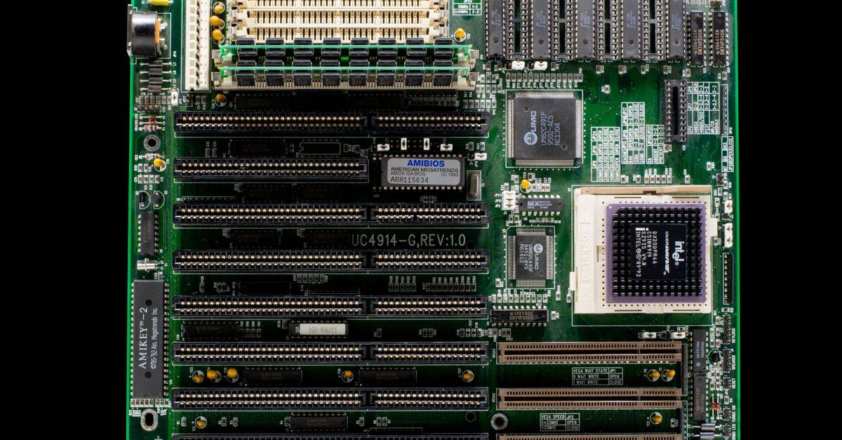 A close-up of a vintage motherboard highlighting microchips and electronic components.
