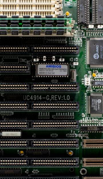 A close-up of a vintage motherboard highlighting microchips and electronic components.