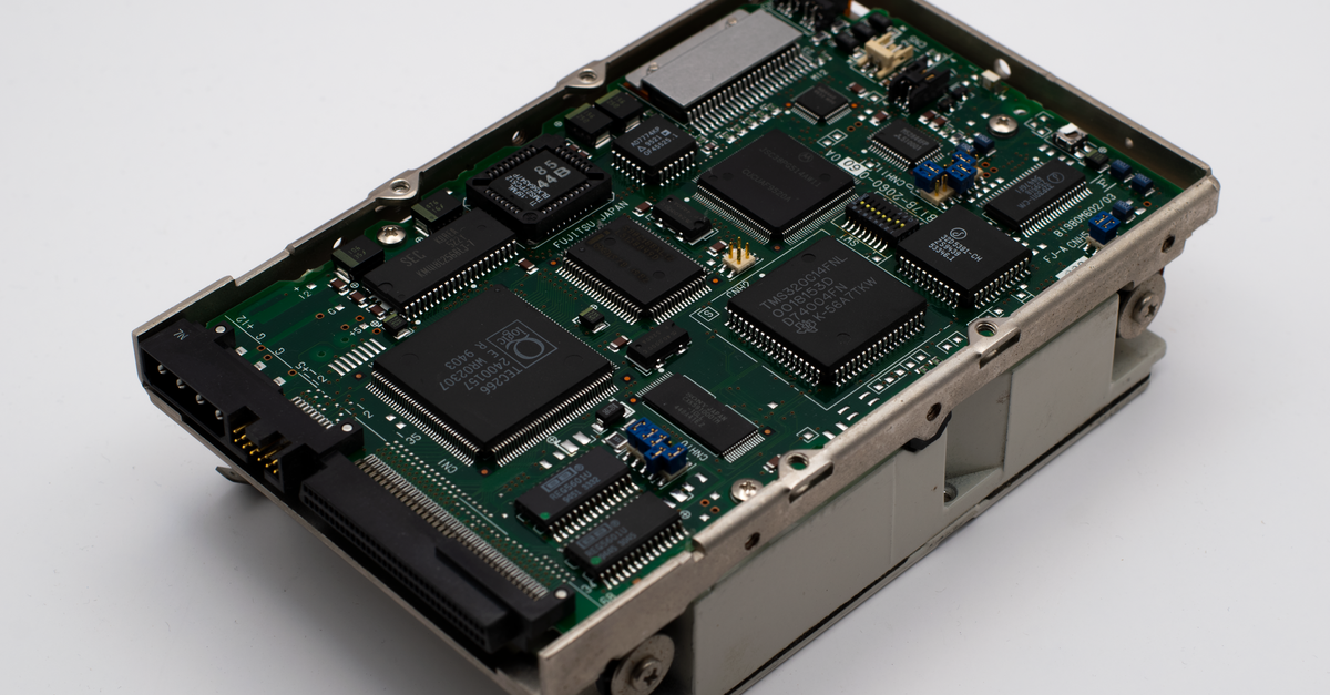 Close-up image of a vintage circuit board displaying microchips and electronic components.